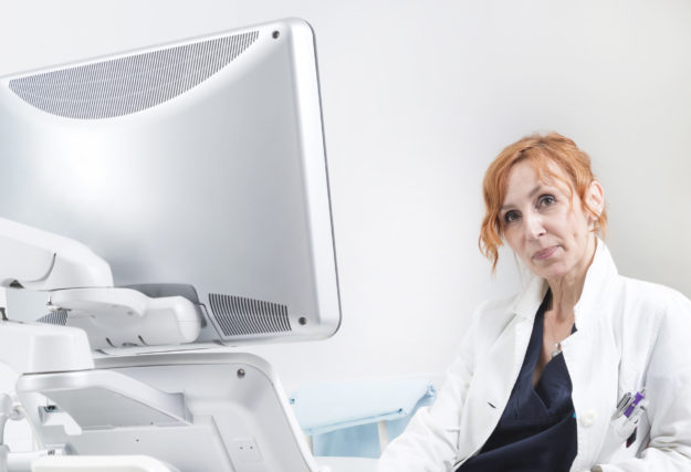 Female doctor at echocardiography machine